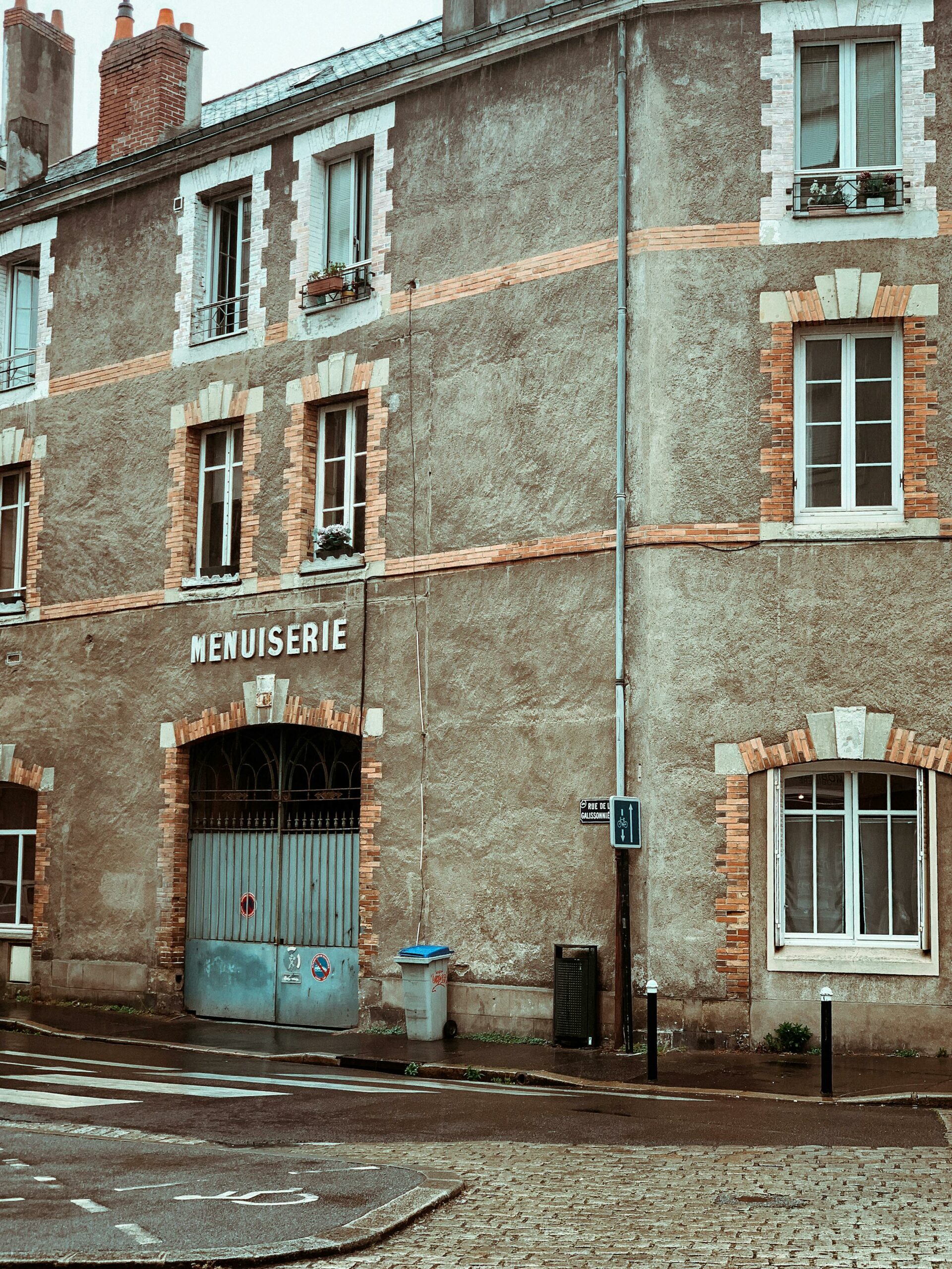 Charming historic urban building featuring unique brick detailing and typical city street scene.